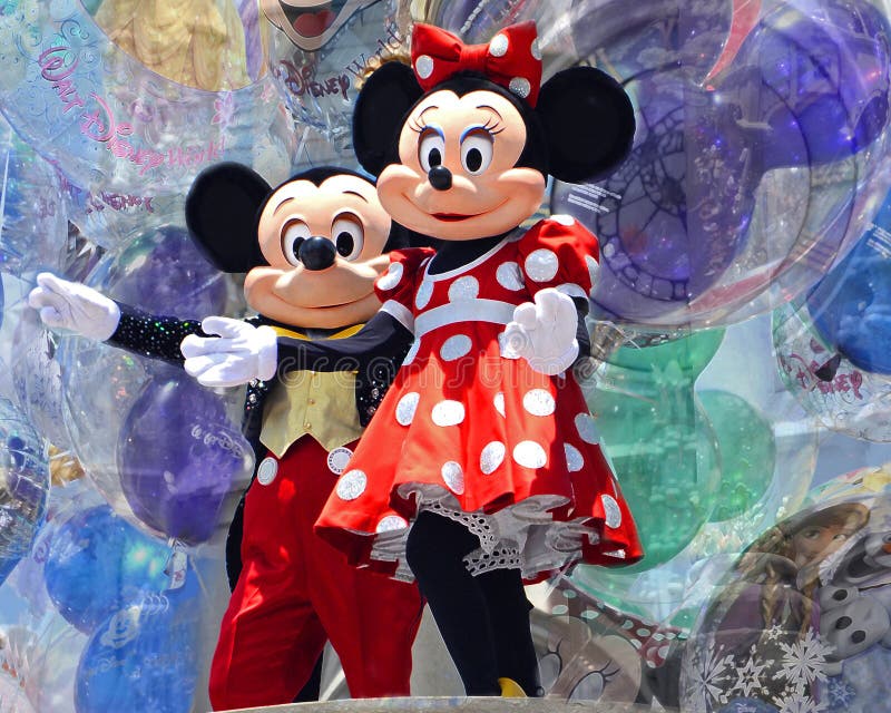 An image of major characters at Disney World against a background of balloons. An image of major characters at Disney World against a background of balloons.