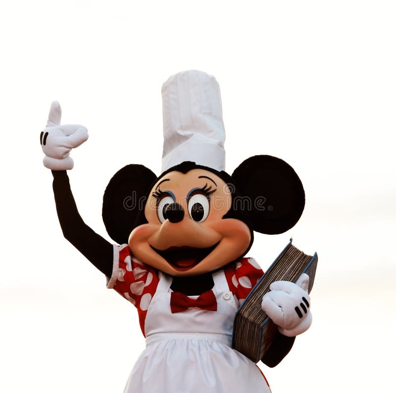 Minnie Mouse as a cook holding a cookbook during a live performance in Disneyland Paris. Minnie Mouse as a cook holding a cookbook during a live performance in Disneyland Paris.