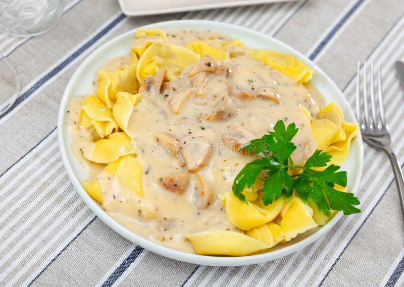Ravioli with mushroom sauce served on platter royalty free stock image