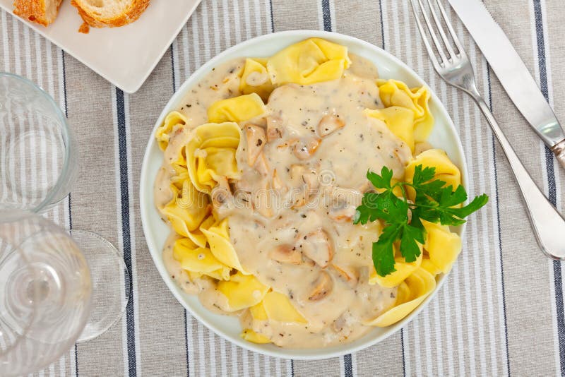 Ravioli with mushroom sauce served on platter royalty free stock image