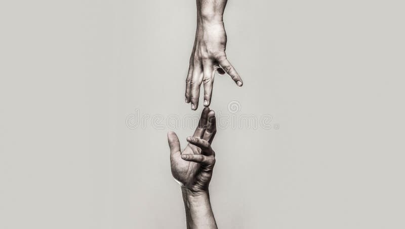 Close up help hand. Helping hand concept and international day of peace, support. Two hands, helping arm of a friend, teamwork. Black and white. Close up help hand. Helping hand concept and international day of peace, support. Two hands, helping arm of a friend, teamwork. Black and white.
