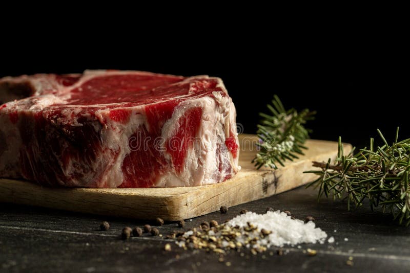 A Raw Beef Chop on a Chopping Board Stock Photo - Image of studio, life ...
