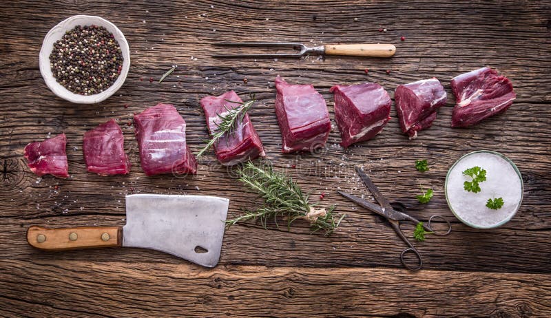 Raw beef meat. Raw beef tenderloin steak on a cutting board with rosemary pepper salt in other positions