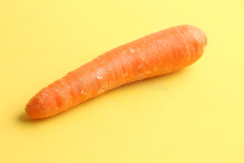 Raw Carrot on a Yellow Surface Stock Photo Image of healthy, organic