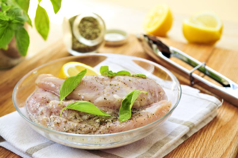 Raw chicken breasts marinating