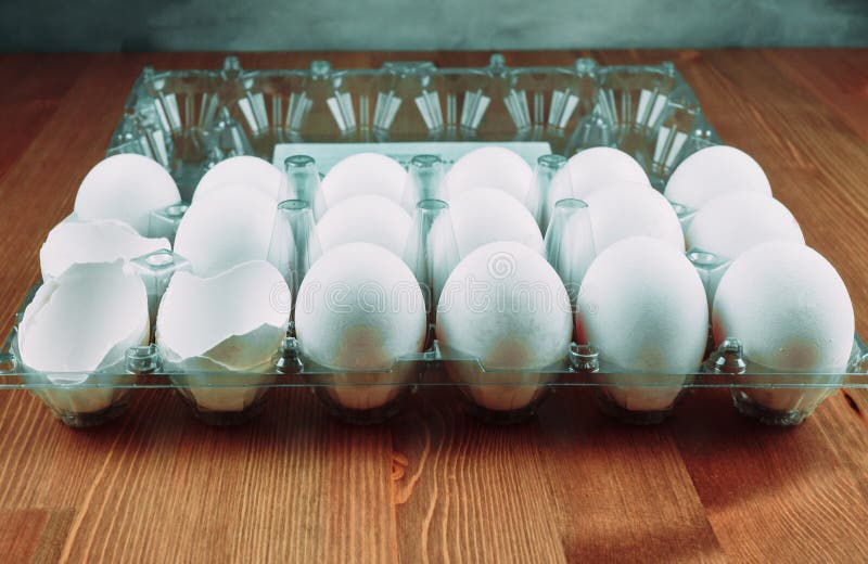 Raw Chicken Eggs with White Shells Lying in a Transparent Plastic