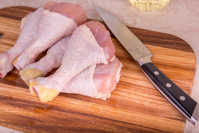 Cutting a chicken leg stock photo. Image of knife, hands 23131700