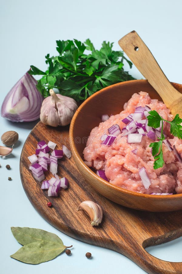 Raw Chicken Mince On A White Plate And On A White Background.Isolate. Closeup Of Chicken Mince