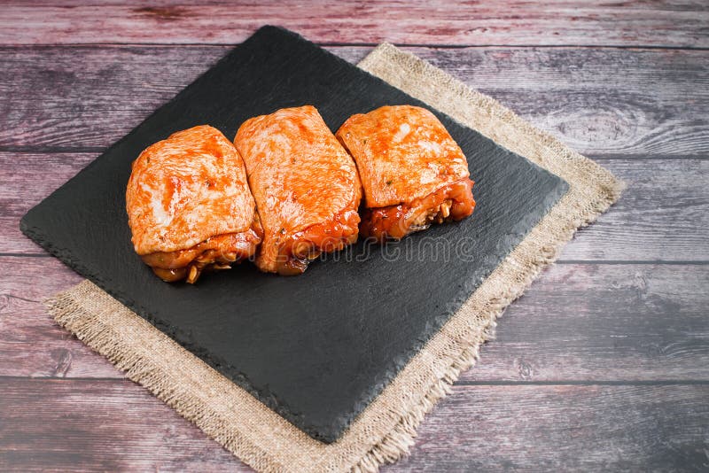 Raw Chicken Thighs Marinated in Red Sauce. Chicken Semicooked Thighs. Top of View. Raw Chicken