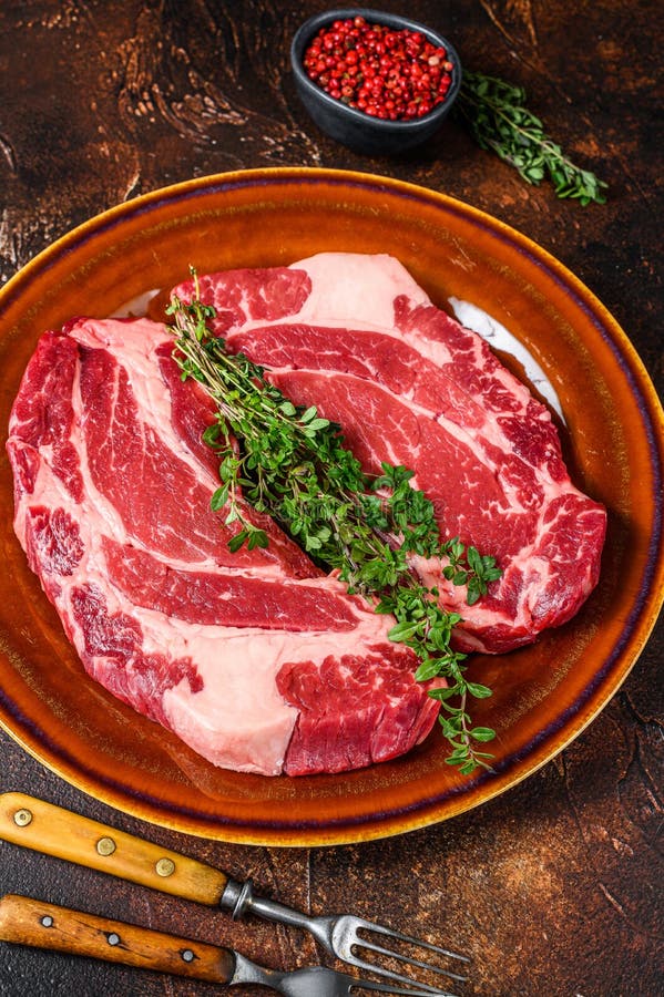 Raw Chuck Eye Roll Steaks Organic Beef Meat. Dark Background Stock