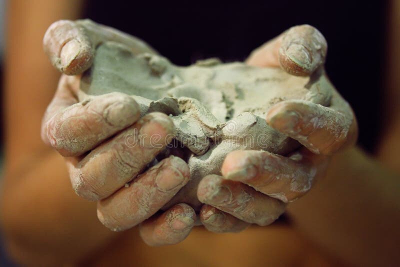 Raw clay in the hands of women royalty free stock image