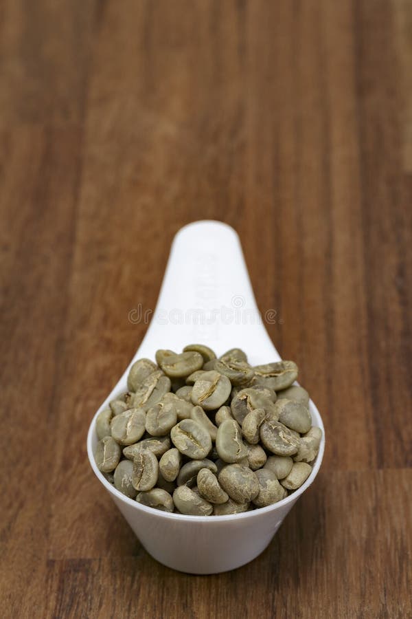 Raw Coffee Beans Sort Dry Process or Natural Process in Measuring Spoon