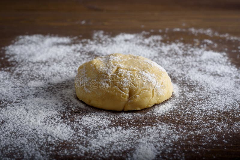 Raw dough ball sprinkled with white flour on a wooden table. stock photos Raw dough ball sprinkled with white flour on a wooden table. stock photos