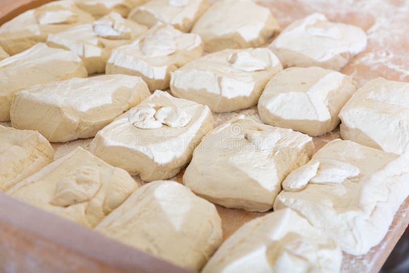 Raw Dough in the Form of Loaves for Baking in Bakery Oven Stock Photo