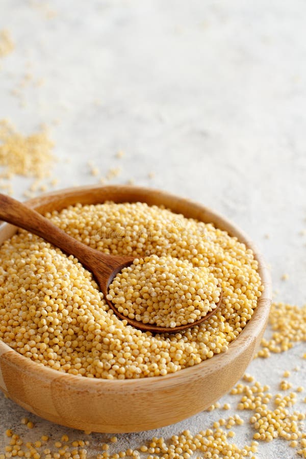 Raw Dry Hulled Millet in a Wooden Bowl with a Spoon Stock Photo - Image ...