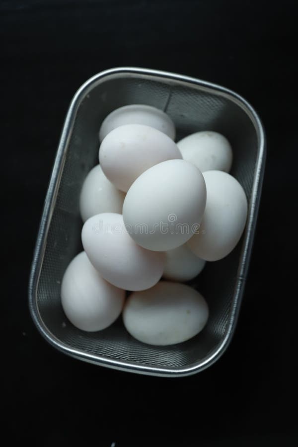 Raw duck eggs in a basket stock photo. Image of group 248884824