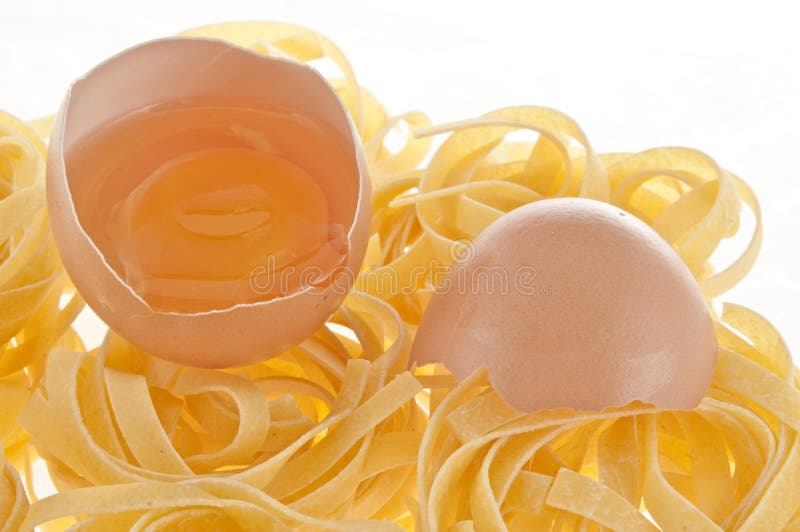Raw egg and pasta. stock photo. Image of pasta, yellow 10738138