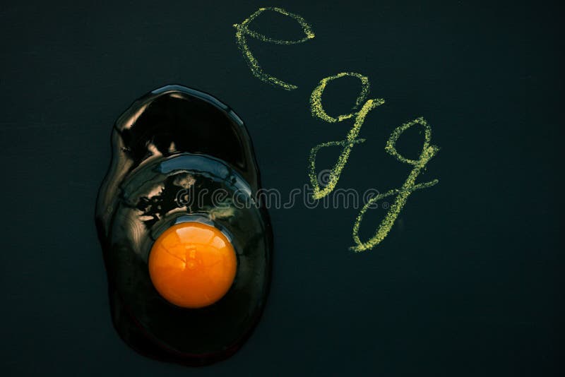 Raw egg yolk on black background