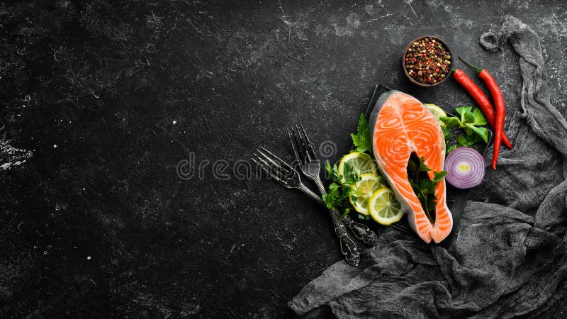 Raw fish steak with parsley and lemon on the table. Salmon Top view.