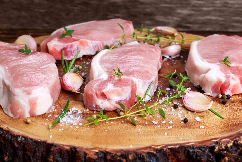 Raw Fresh Boneless Pork Chops with herbs