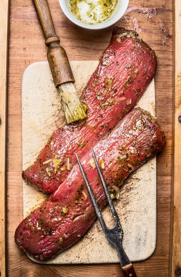 https://thumbs.dreamstime.com/b/raw-fresh-lamb-fillet-marinating-cooking-bbq-grill-brush-meat-fork-top-view-close-up-65035950.jpg