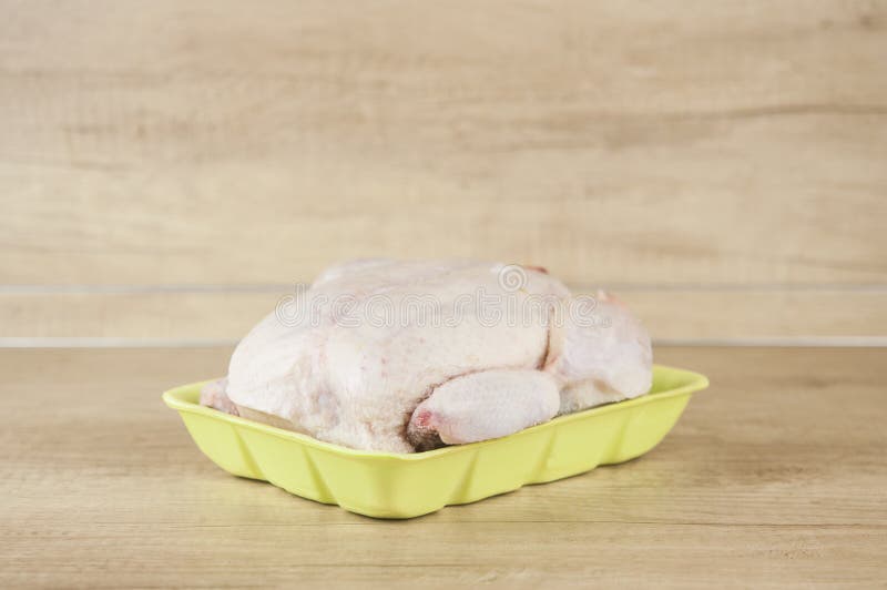 Frozen chicken in the frost on the table