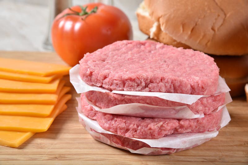 Raw ground beef patties stock photo. Image of board 148913088