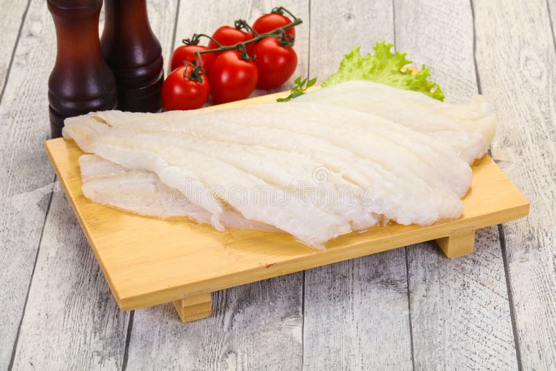Raw halibut fillet stock photo. Image of board, closeup 148270744