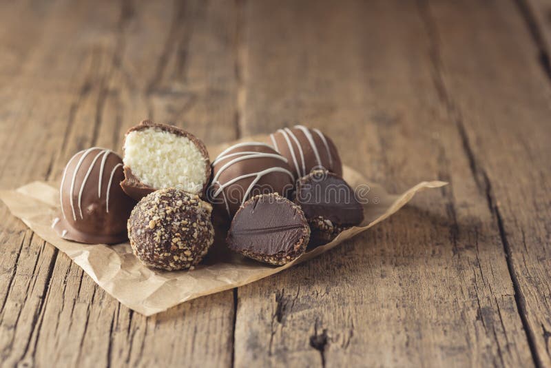 Raw Homemade Vegan Chocolate and Coconut Candies Healthy Vegan Dessert Tasty Chocolate Candies on Old Wooden Background Horizontal stock photography Raw Homemade Vegan Chocolate and Coconut Candies Healthy Vegan Dessert Tasty Chocolate Candies on Old Wooden Background Horizontal stock photography