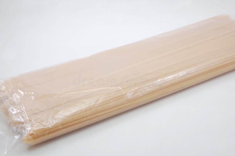 Raw Long Sticks Spaghetti Noodle Pasta in Plastic Pack Stock Photo