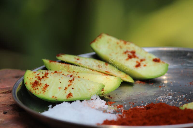 Raw Mango Slice with Salt and Red Chili Spice Photo. Stock Photo ...