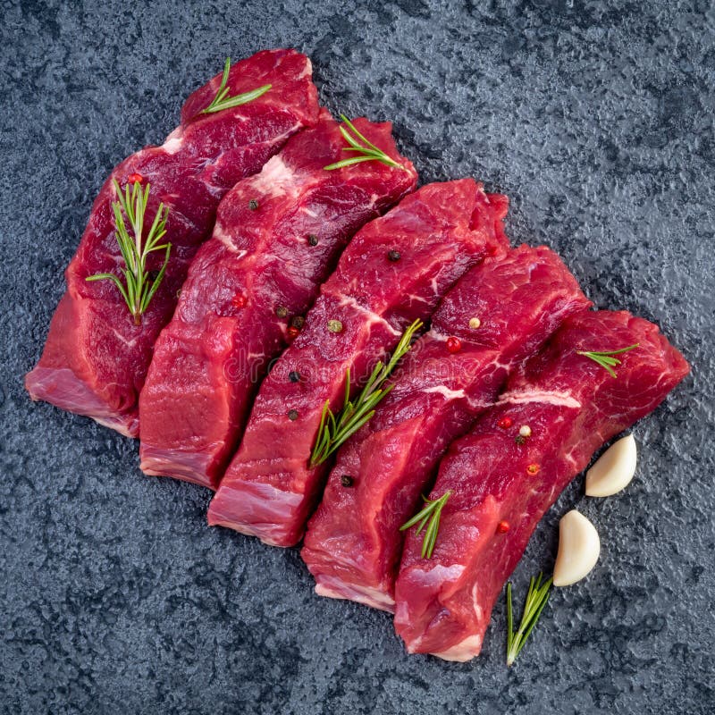 Raw Meat, Beef Steak with Seasoning on a Black Stone Table, Top Stock Photo Image of bloody