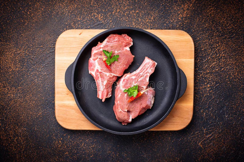 Raw meat in cast iron pan stock image. Image of knife 118442507