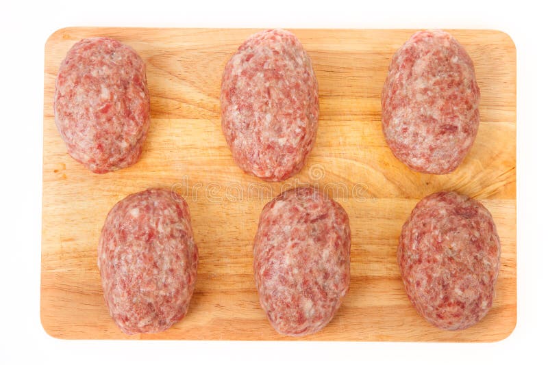 Raw Meat Patties On A Wooden Board On A White Background Stock Photo