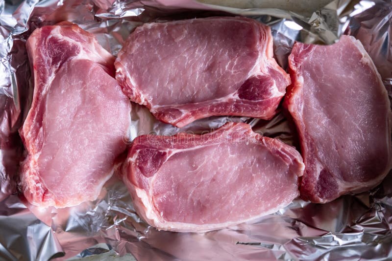 Raw Meat Steaks on Foil. Pig Meat Stock Photo Image of lunch, pack