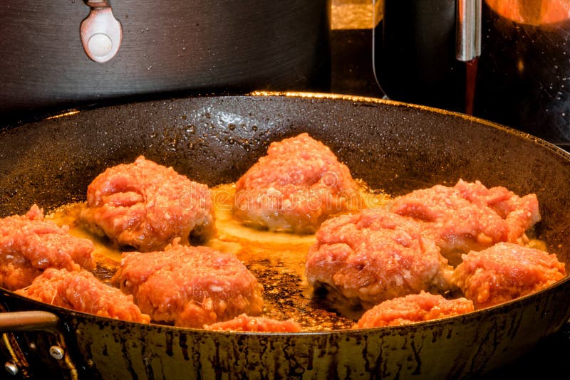 Raw meatballs on a frying pan