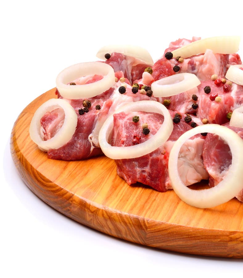 Raw Meet Pieces, Sliced Onion and Black Pepper on the Board Stock Image