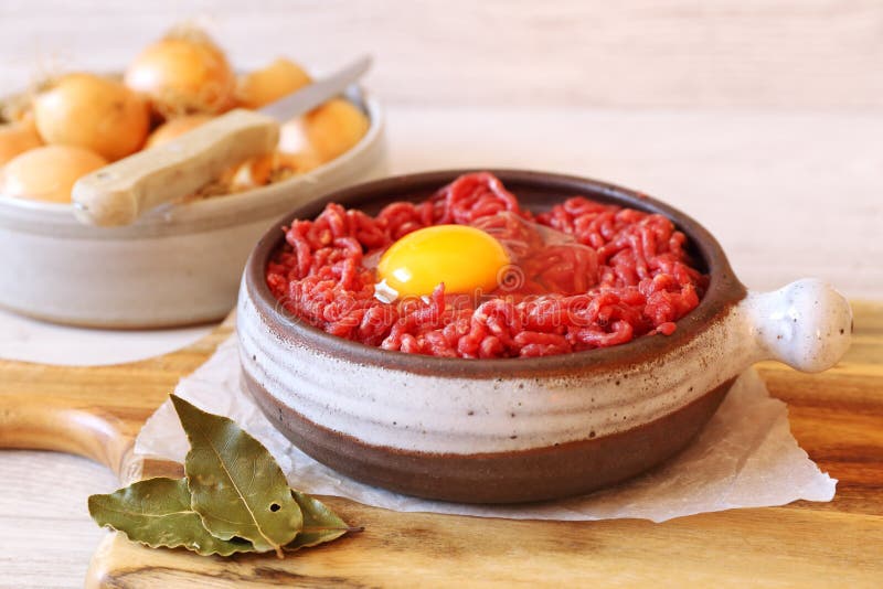 Raw Minced Meat with Egg, Olive Oil, Spices and Onions Stock Photo
