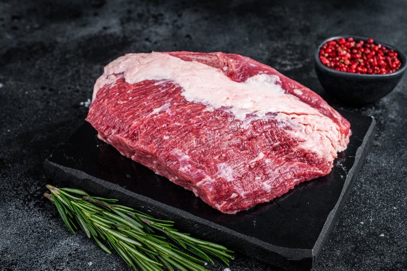 Raw Outside Round Roast Beef Meat Cut on a Marble Board. Black