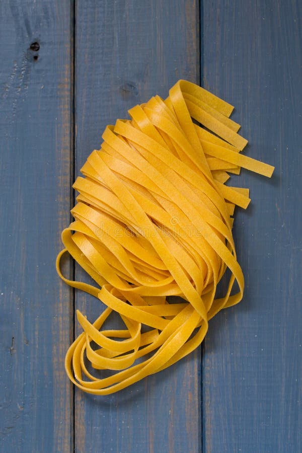 Raw pasta on blue