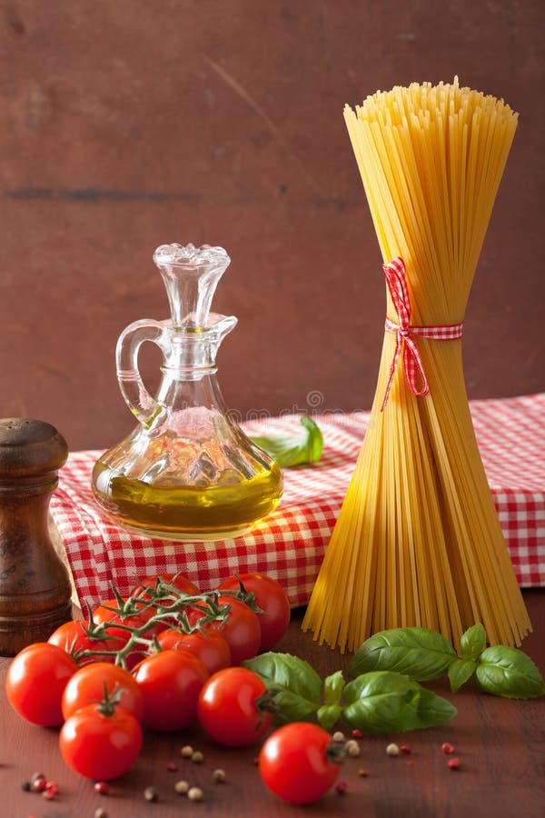 Raw Pasta Olive Oil Tomatoes. Italian Cuisine in Rustic Kitchen Stock