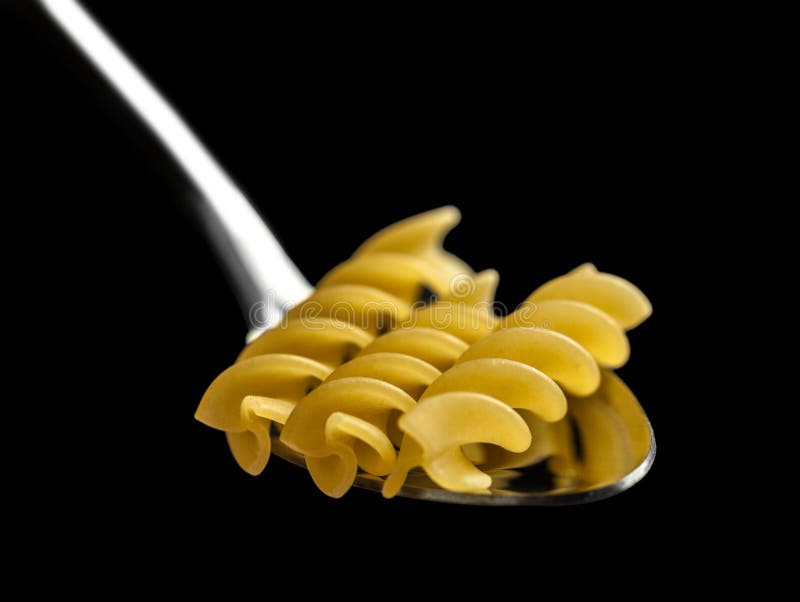 Raw pasta in spoon closeup stock photo. Image of macro 61797948