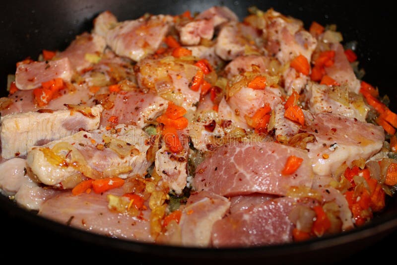 Raw pieces of meat with vegetables cooked for roasting stock photo