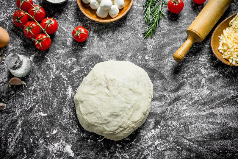 Raw Pizza. Dough with Different Ingredients for Cooking Homemade Pizza