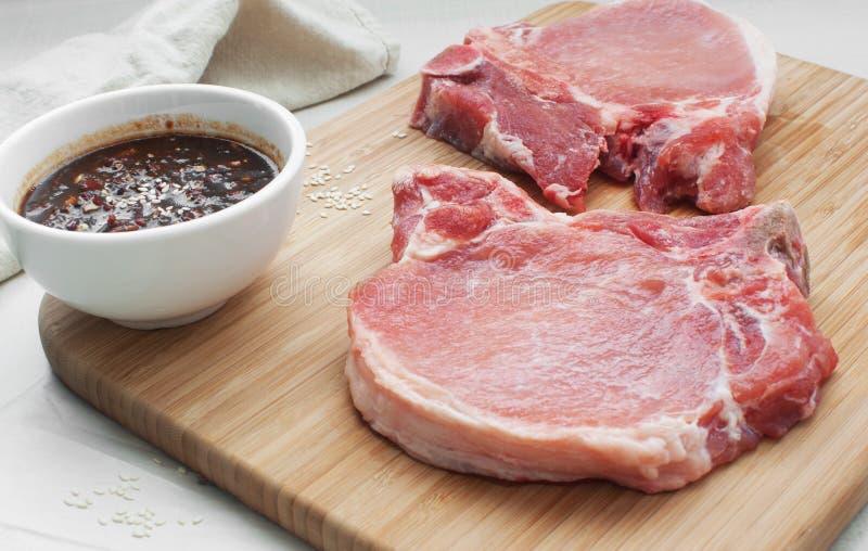 Raw pork chops with hot sauce