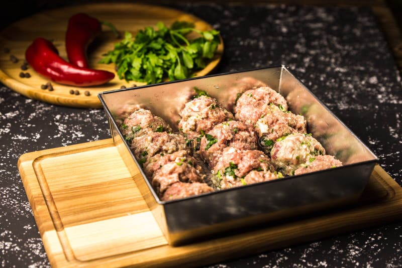 Raw pork cutlets in a metal baking dish royalty free stock photography Raw pork cutlets in a metal baking dish royalty free stock photography