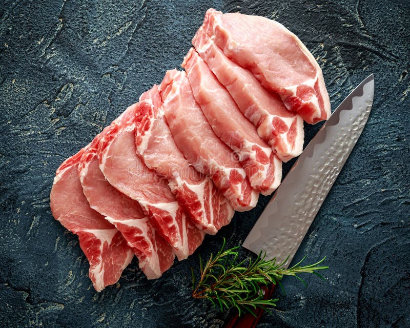 Raw Pork Loin chops with herbs, rosemary, thyme, pepper and knife