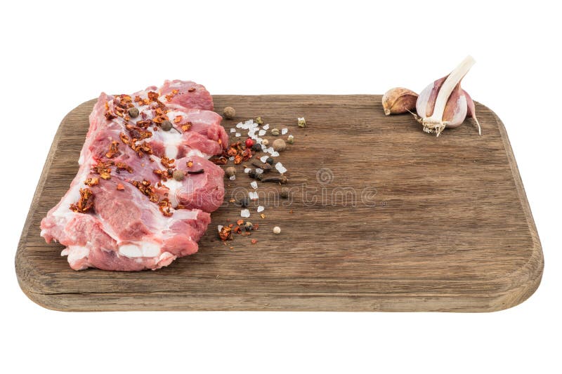 raw pork ribs with chili peppers on cutting board isolated on white. stock images raw pork ribs with chili peppers on cutting board isolated on white. stock images