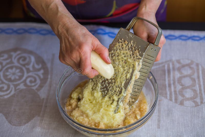 Raw Potatoes Shredded on a Grater Stock Photo - Image of arms