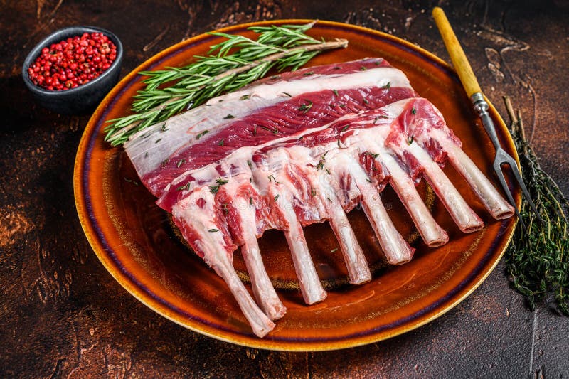 Raw Racks of Lamb Ready for Cooking. Dark Background Stock Photo